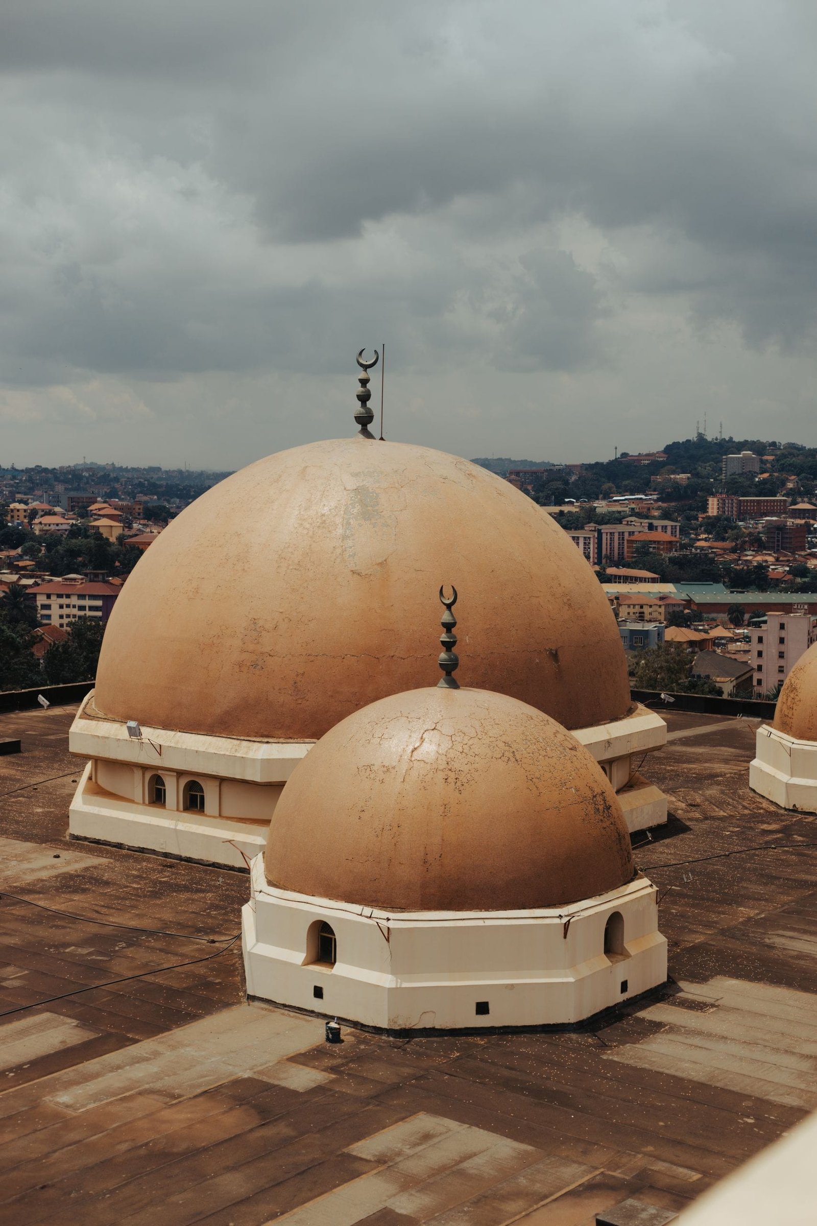 A striking aerial view of the domes of a mosque in Kampala, showcasing islamic architecture.
